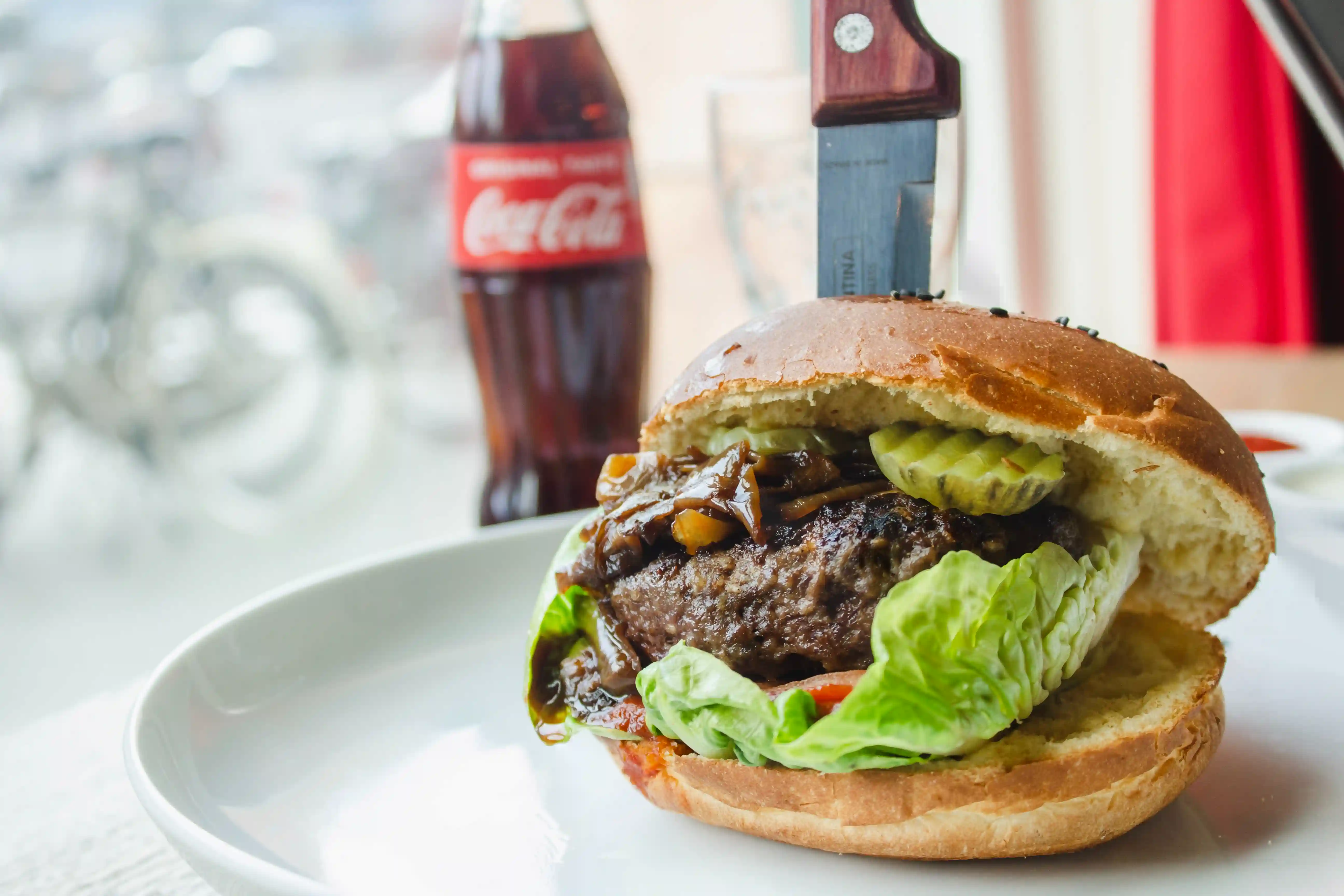 Food on a plate next to a coke